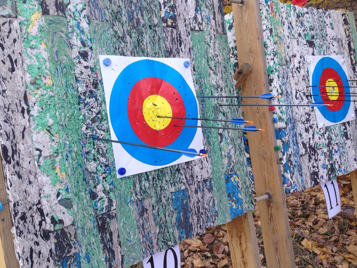 My first ever arrows shot at distance from recurve, grouped on a target face.