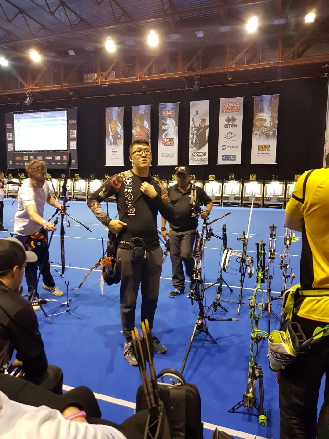 Standing on the blue competition floor at the Nimes archery tournament, 2018.