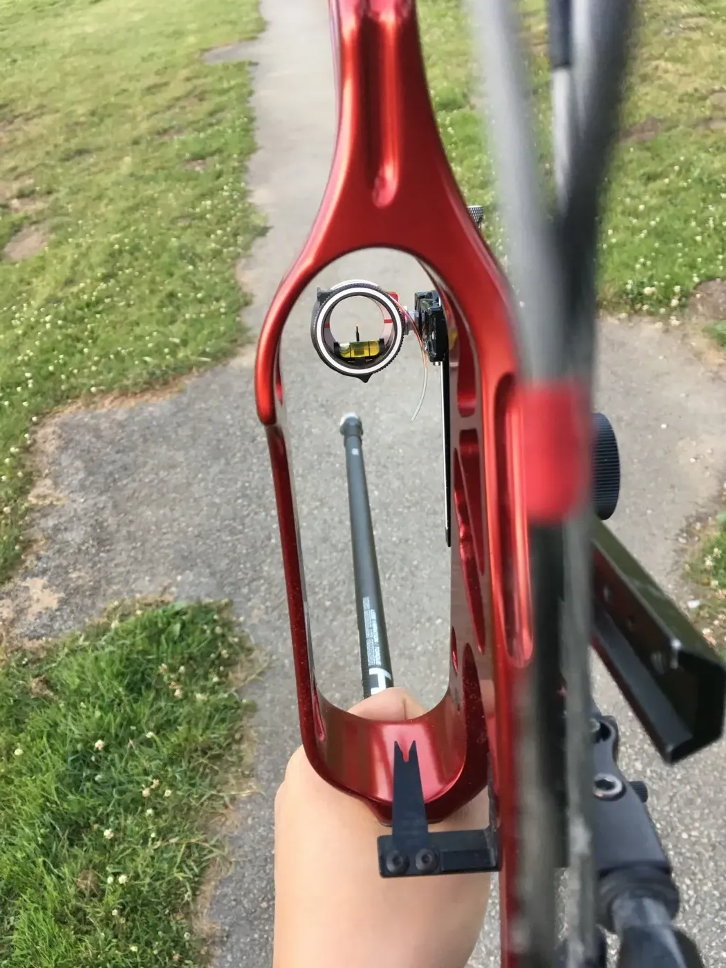 Looking through a compound bow's peep sight while training in Golden Gate Park.