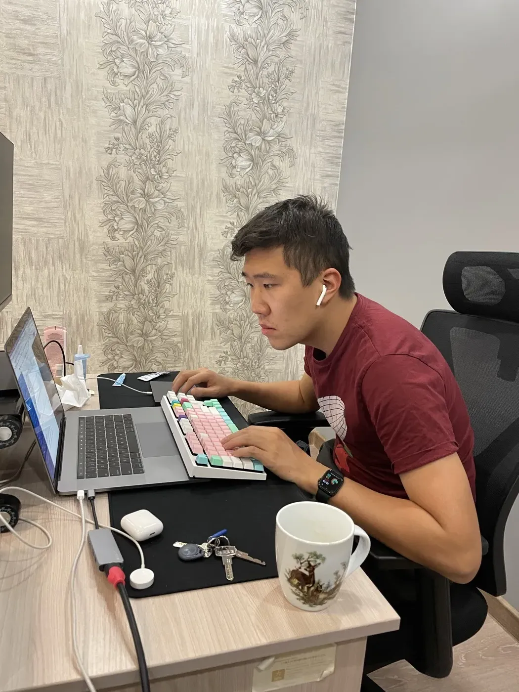 At a desk working on a laptop, the period back in Almaty focused on a software career.